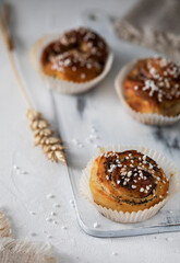 
Fresh cinnamon buns on wooden cutting board
