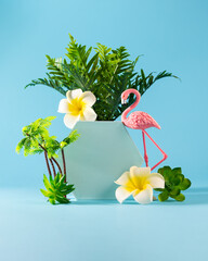 Summer weekend party concept. Flamingo, palms and tropical flower on blue background.