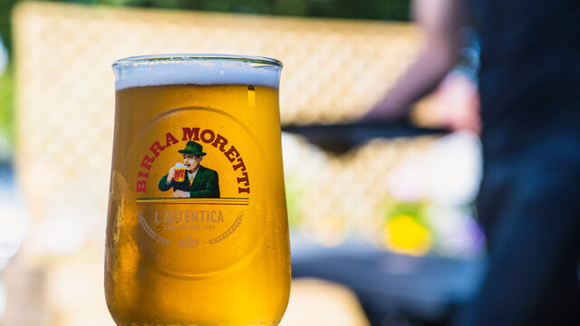 A glass of Birra Moretti beer shot in an outdoor pub garden setting, 13th June 2021, in Loxley, Warwickshire