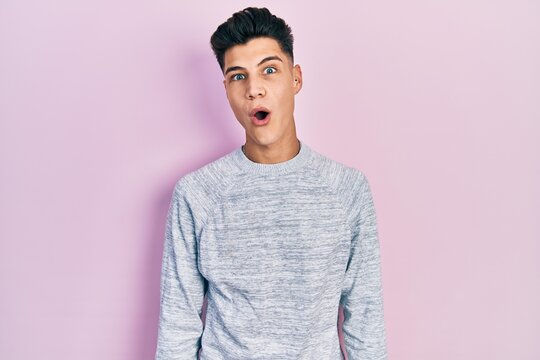 Young hispanic man wearing casual clothes afraid and shocked with surprise expression, fear and excited face.