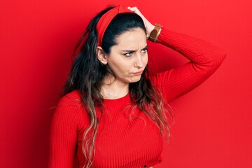 Young hispanic woman wearing casual clothes confuse and wondering about question. uncertain with doubt, thinking with hand on head. pensive concept.