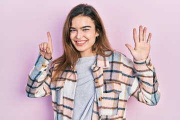 Young caucasian girl wearing casual clothes showing and pointing up with fingers number six while smiling confident and happy.