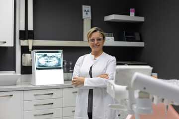 Portrait of dentist looking at camera inside dental clinic