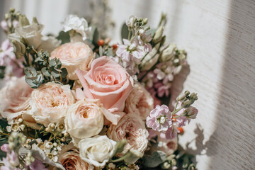 Wedding bouquet of peonies flowers on the floor of the newlyweds