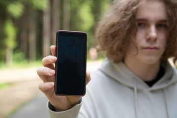 The man uses a smartphone to access the Internet. Using a smartphone.