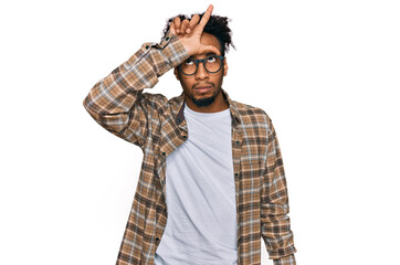 Young african american man with beard wearing casual clothes and glasses making fun of people with...