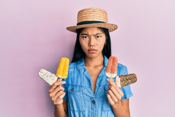 Young chinese woman wearing summer style holding ice cream skeptic and nervous, frowning upset because of problem. negative person.