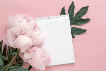notepad and peony flower on pink background, concept of goal setting, summer plans, wish list, shopping, blank message sheet, romantic card, mock up for design © Leka