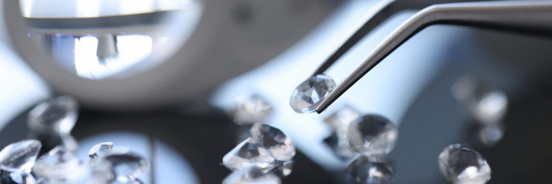 Closeup of diamond stone in metal tweezers