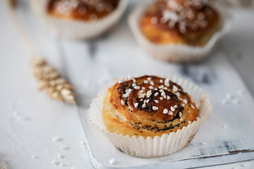 Fresh cinnamon buns on wooden cutting board