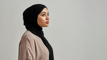 Portrait of attractive young arabic woman in black hijab