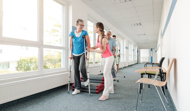 Seniors in rehabilitation learning how to walk with crutches