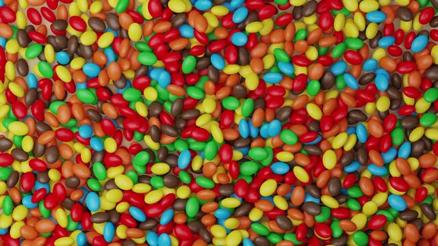 Bright and colorful candy beans or peanuts. Multicoloured tasty sugar sweets. Chocolate candies. Close up video. Red, green, orange, blue, yellow, brown colors. Holiday mood 3D Render concept. 4K clip