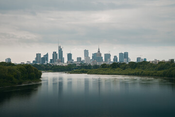 Skyline of the city of Warsaw, the capital of Poland, in which we can see the most emblematic buildings. Reflection on the river Vistula, cloudy day Wisla.