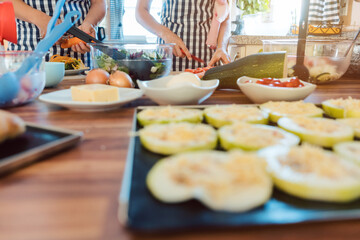 Women preparing dishes for garden party in the kitchen