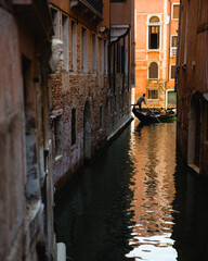 Obraz na płótnie Canvas Venice Canal with Gondola Driver Kicking Off