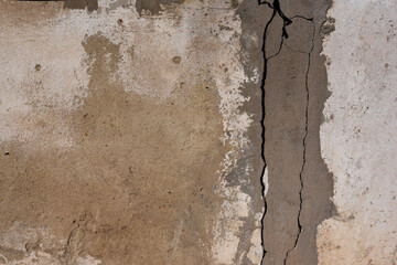 Texture of old gray brown concrete cracked wall for background. Abstract gray brown cement wall texture and background. Shabby building facade with damaged plaster. Copy Space.