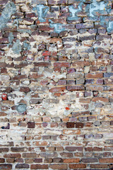 Multicolored red bricks with grey and white mortar