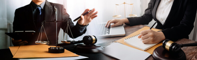 Justice and law concept.Male judge in a courtroom with the gavel, working with, computer and...
