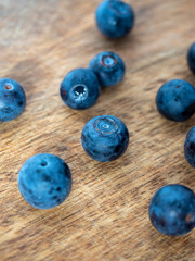Close-up of ripe delicious blueberries on a wooden background. Healthy natural products, vitamins. selective focus. Top view, flat lay.