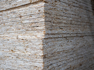 Close-up of a stack of OSB sheets. Lumber, construction, selective focus