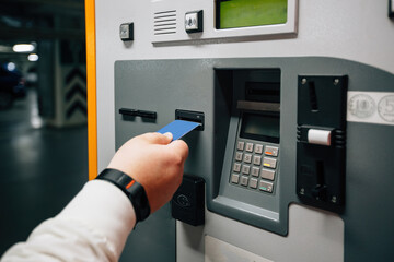 Man pays for underground parking using payment terminal