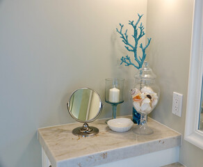 Bathroom vanity with candle, mirror and shells
