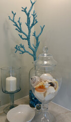 closeup of vanity with seashells, mirror and candle