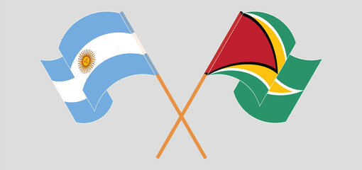 Crossed and waving flags of Argentina and Guyana