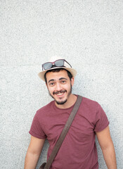Young tourist looking at camera while smiling.