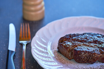 Closeup of delicious juicy meat steak on white plate, selective focus