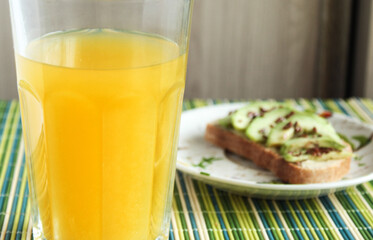 healthy sandwich with avocado flax seeds and orange juice 