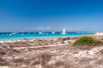Luxury boats anchored near the beach of Ses Illetas. Wild beach on the island of Formentera, Spain