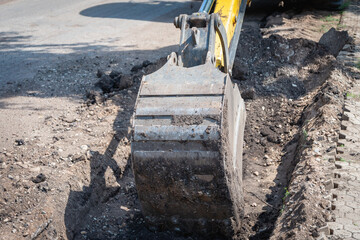 Digging a trench with an excavator.