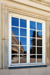 Royal Castle in Warsaw reflected in the glass window. Warsaw Old Town, Poland