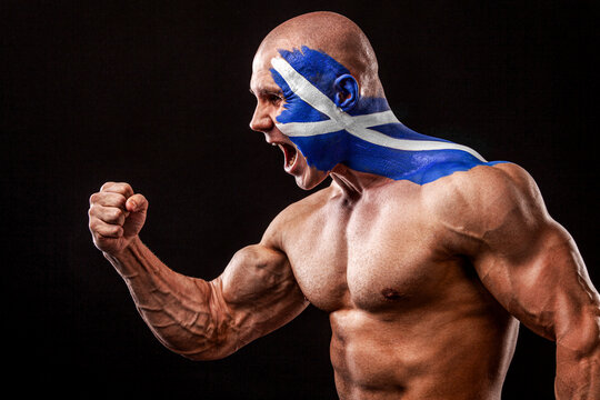 Scotland fan. Soccer or football athlete with flag bodyart on face. Sport concept with copyspace.