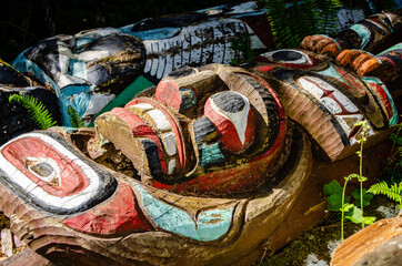 Face of the Totem Pole - The colours and style of the face of a totem pole remains strong despite the pole having fallen along the trail