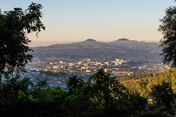 View with small city, mountains and forest