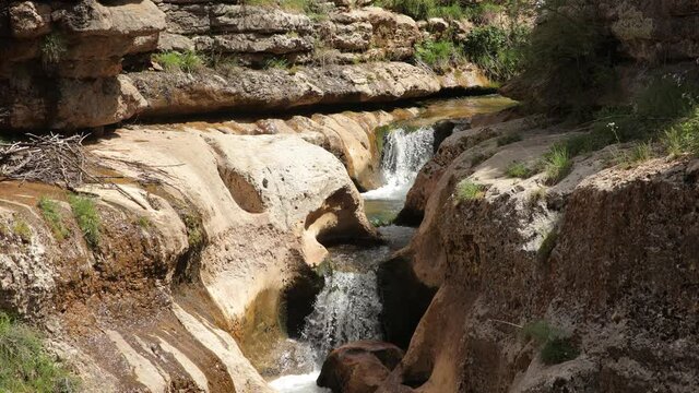 Mountain waterfall in Lebanon. The river flows on the slopes of the mountains forming a waterfall in a beautiful landscape.
