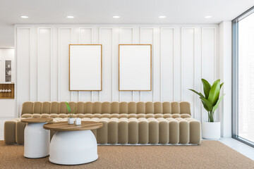 White office waiting room interior with sofa and two vertical posters