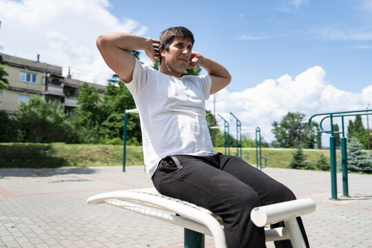 Adult Caucasian Man Training Outdoor Male Doing Sit Ups In Sunny Day Street Workout Real People Concept