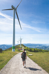 Obraz premium Young caucasian man near windmills at the top of Oiz mountain; Basque Country.
