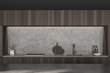Cupboards with built in sink and cooker in dark wooden kitchen interior