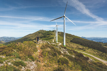 Young caucasian man near windmills at the top of Oiz mountain; Basque Country.