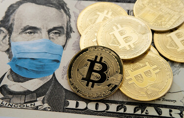 Cryptocurrency regulation in the United States after COVID-19 pandemic. Concept. Picture of Bitcoin coins placed on 5 dollars note with applied anti virus face mask (digital montage).