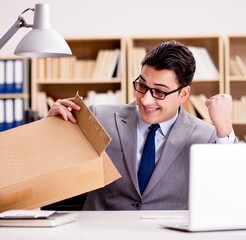 Businessman receiving parcel in office