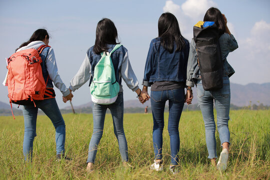 Group of teenger tourist back pack hand to hand walk hiking together
