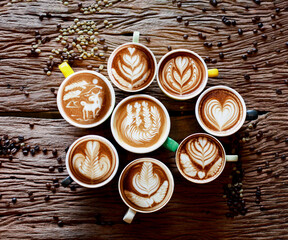 Variety coffee latte art on hot coffee againt ratro wooden background