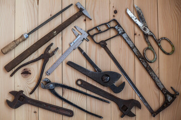 Top view of an old tool on a light wooden background for building or renovation. A set of hand tools for construction. Craftsman tools. Concept for father's day.