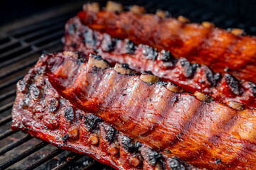 2 slabs of ribs smoking on grill outside
